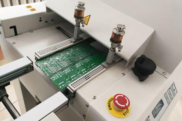 PCB on the rails entering reflow oven