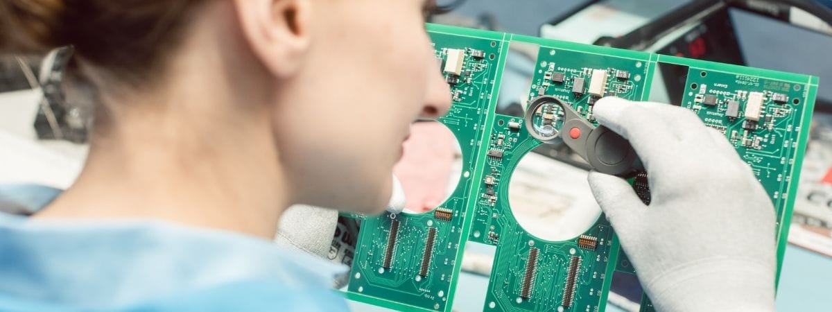 Technician Soldering Components to a PCB