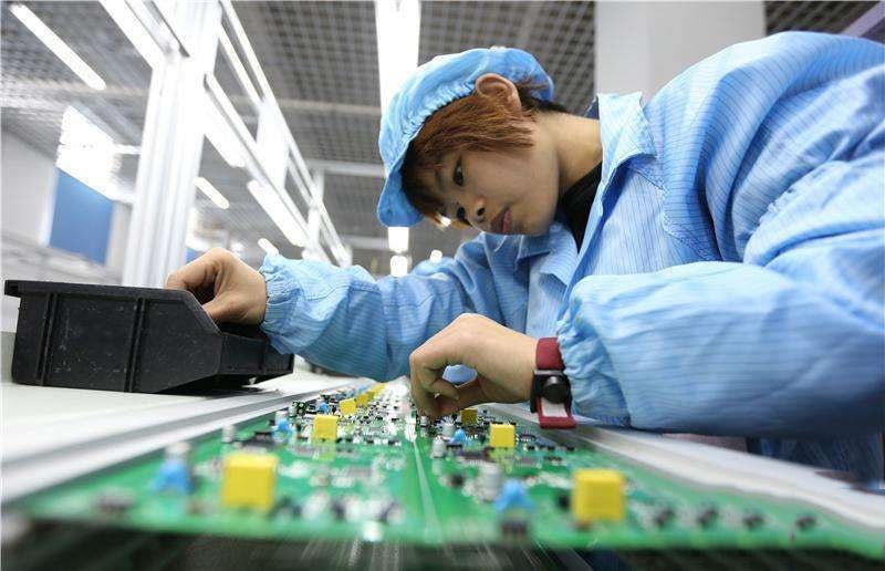 Workers are working on PCB assembly